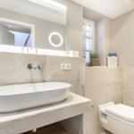 Bathroom with sink, mirror, and toilet