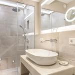 Bathroom with shower, sink, and mirror