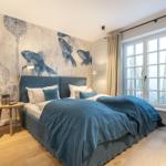 Bedroom with bed, fish wall and window