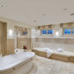 Bath with whirlpool, shower, and seating area with windows