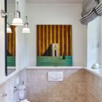 Bathroom with sink, toilet, and wall art