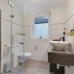 Bathroom with shower, toilet, and sink