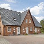 Red brick house with gray roof and multiple entrances.