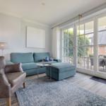 Living room with sofa, armchair, and terrace door