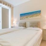 Schlafzimmer mit Doppelbett, Fenster und Wandbild