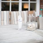 Wooden table with drinks and shell terrarium outdoors