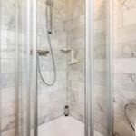 Shower with marble wall and showerhead