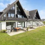 Modern vacation home with balcony, terrace, and garden.