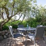 Garden with table and chairs under trees