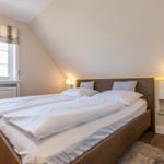 Bedroom with double bed, window, and nightstands.