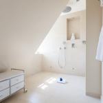 Shower with skylight and sink in bathroom