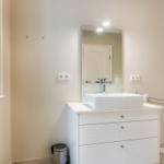 Bathroom with sink, mirror, and heater