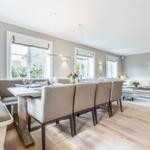 Dining room with bench, table and chairs. Living area with sofa and coffee table.
