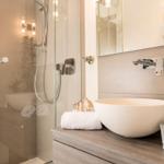 Bathroom with shower cabin, sink, and towel