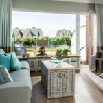 Living room with sofa, coffee table, and garden view