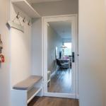 Entrance with bench, hooks, and mirror. Corridor to the kitchen.