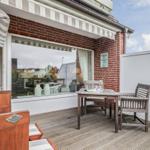 Terrace with table, chairs, and view into the house