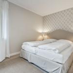 Bedroom with double bed, window and bedside table