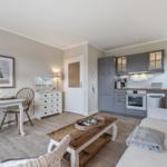 Living kitchen with sofa, dining table, and kitchen cabinets.