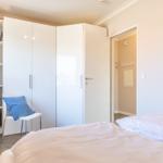 Bedroom with bed, wardrobe, and desk