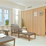 Sauna room with two lounge chairs and view of water