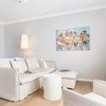 Living room with sofa, TV, and wall painting