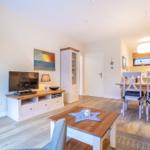Living and dining area with wooden furniture and TV