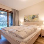 Bedroom with double bed, nightstand, and window to terrace.