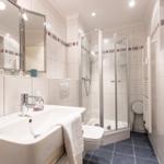 Bathroom with shower, sink, and toilet