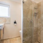 Bathroom with shower, sink, and toilet.
