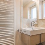 Bathroom with sink, mirror, and heater.