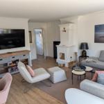 Living room with sofa, TV, and fireplace