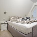 Schlafzimmer mit Doppelbett, Nachttisch und Fenster