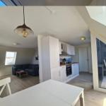 Living kitchen with dining area, bedroom and windows