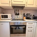 Kitchen with stove, microwave, and countertop.