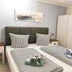 Bedroom with double bed, two nightstands, and wardrobe.