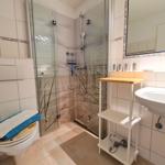 Bathroom with shower, sink, and toilet.