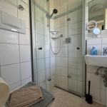Bathroom with shower, sink, and toilet.