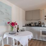 Kitchen with dining table, wall art, and kitchen appliances.