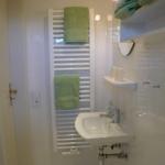 Bathroom with sink, towel rack, and towels.