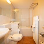 Bathroom with shower, sink, and toilet.