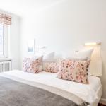 Bedroom with bed, window, and wall art.