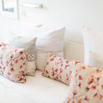 Bed headboard with pillows and wall lamp