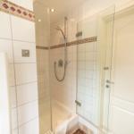 Bathroom with shower, bathtub, and heater