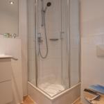 Bathroom with shower, sink, and toilet.