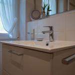 Sink with mirror and window in bathroom