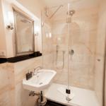 Bathroom with shower, sink, and mirror