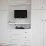 Wall unit with TV and drawers in the bedroom.