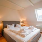 Bedroom with double bed, two nightstands, and skylight.
