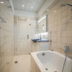 Bathroom with bathtub, shower, and sink